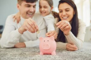 family-placing-coins-in-piggy-bank.jpg
