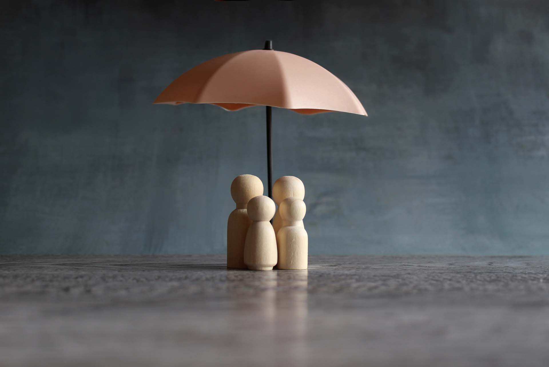 wooden-dolls-covered-by-umbrella.jpg