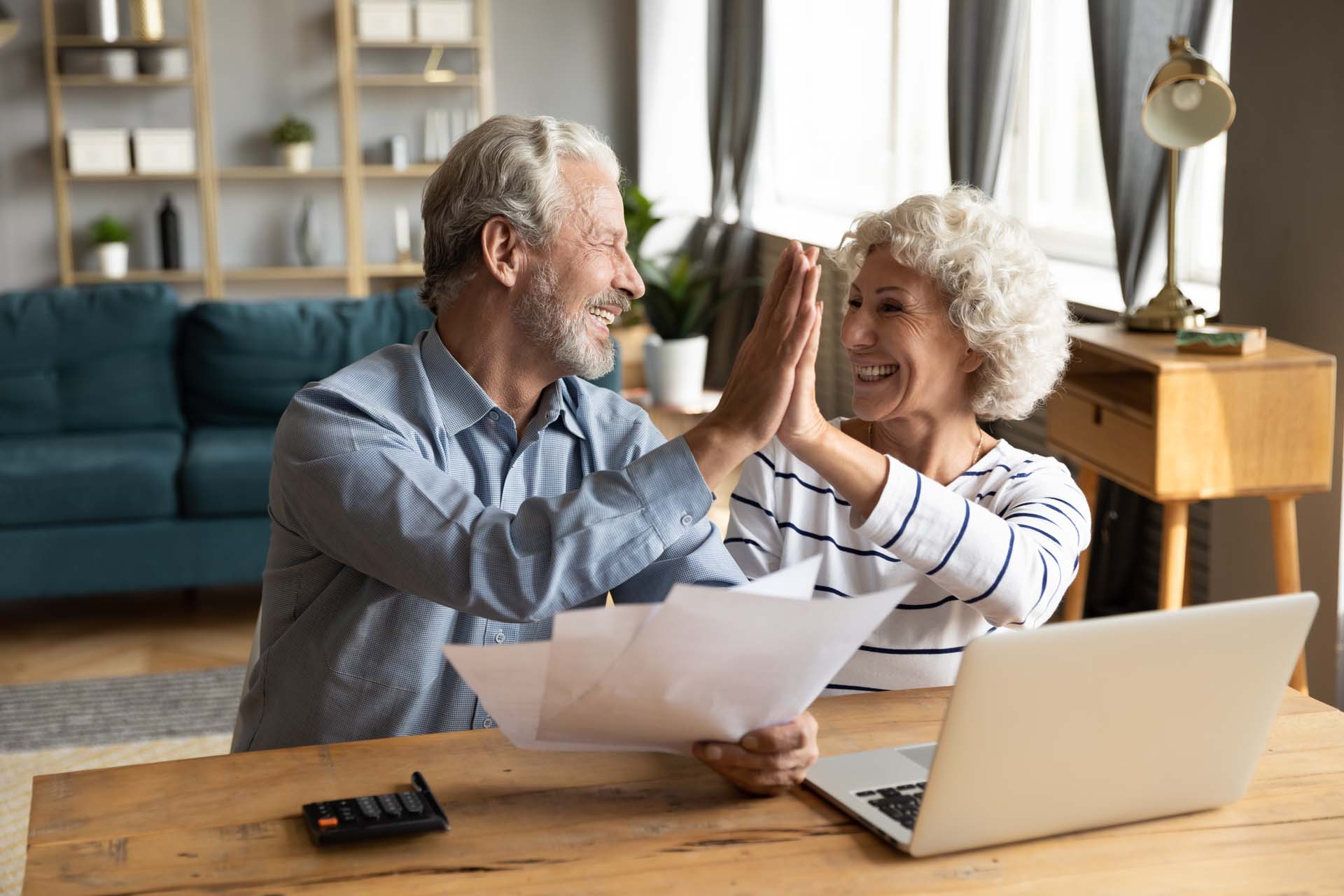 euphoric-middle-aged-married-couple-giving-high-five.jpg