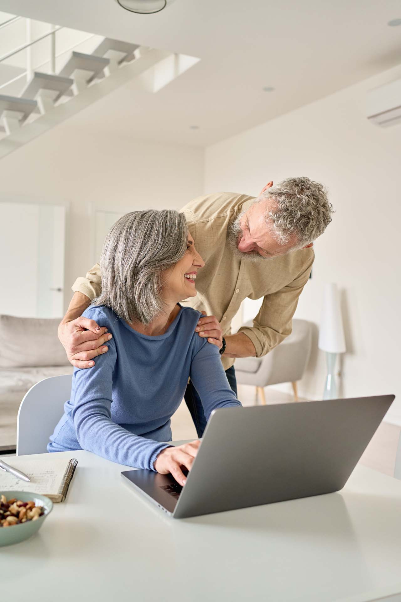 happy-mature-senior-couple-laughing-using-laptop.jpg