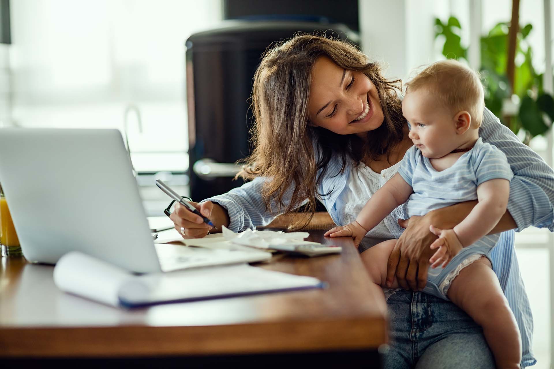 happy-mother-talking-to-her-baby-while-working-at-home.jpg