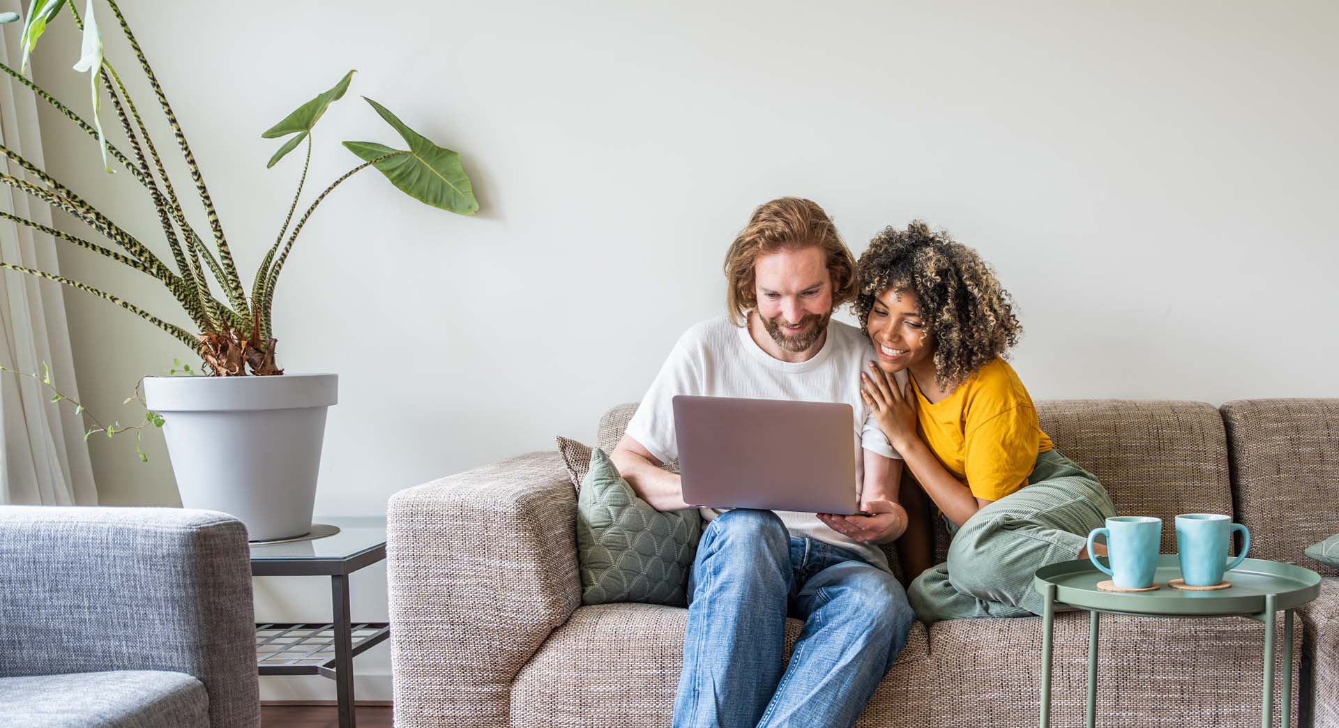 multiracial-young-couple-watching-computer-laptop.jpg