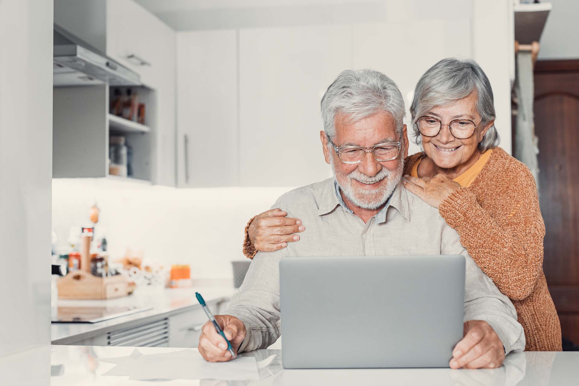 elderly-couple-smiling-looking-at-laptop.jpg
