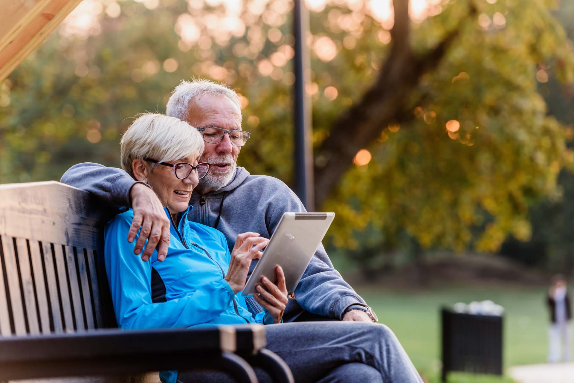 smiling-senior-active-couple-sitting-on-the-bench.jpg